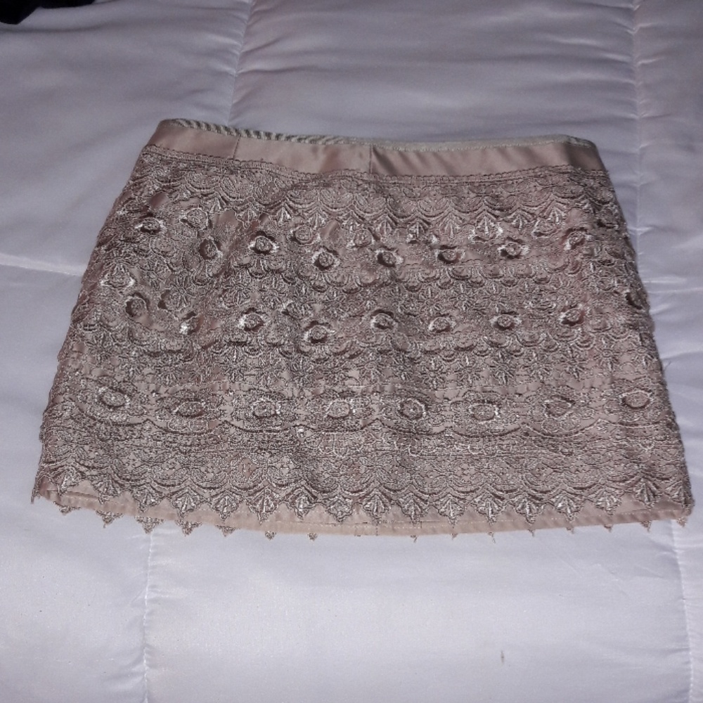 Above knee cute small tan skirt. Dressy or casual.